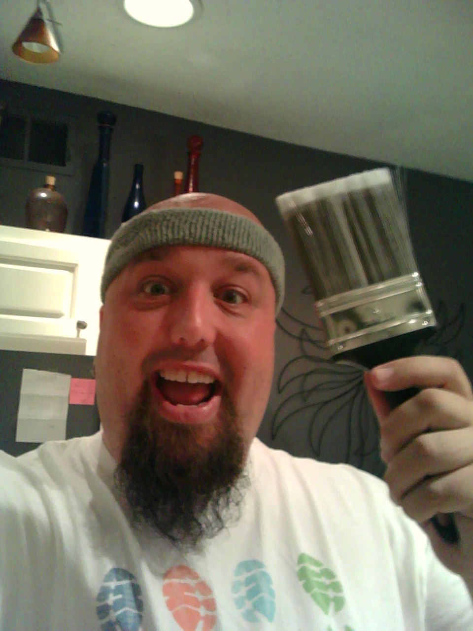 a man is smiling and holding a beer mug