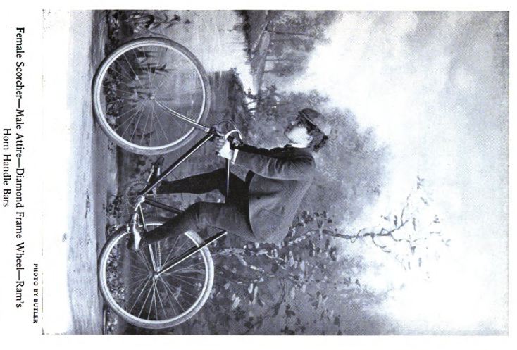 a man leaning on a bike, with a coat over his coat