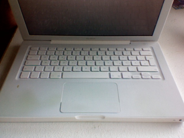 an open laptop computer sitting on top of a counter