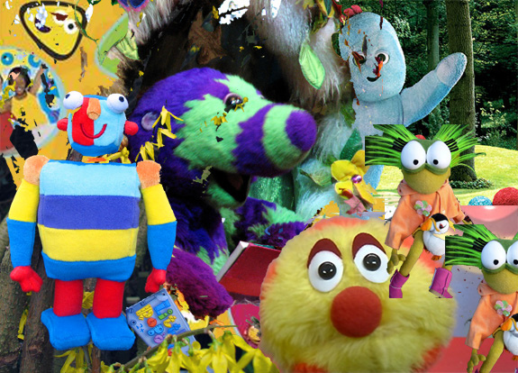 a group of people stand near colorful plush toys