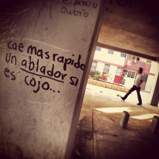a person walking under an overpass with writing on it