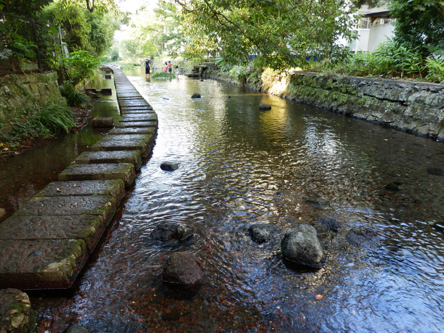 stone steps lead up to a river, where you can see a couple of rocks