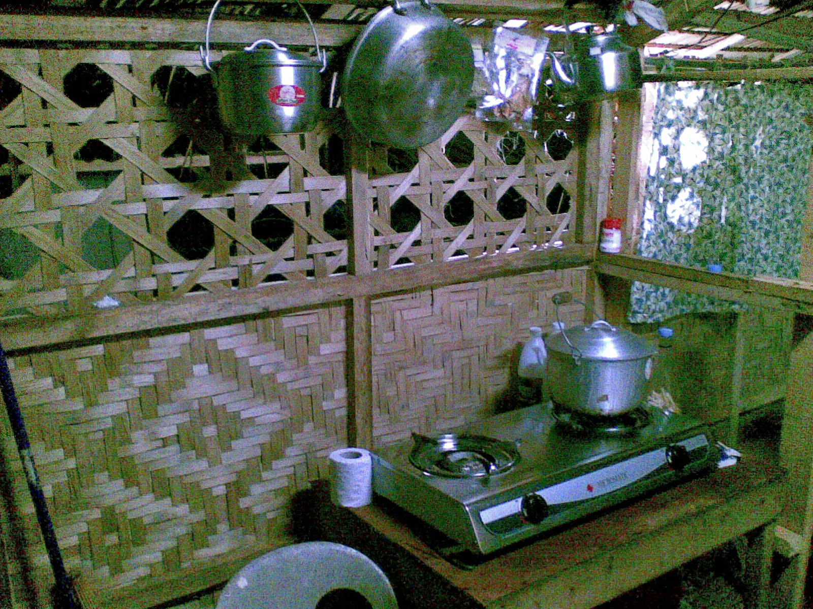 a stove top with pots hanging from it's side
