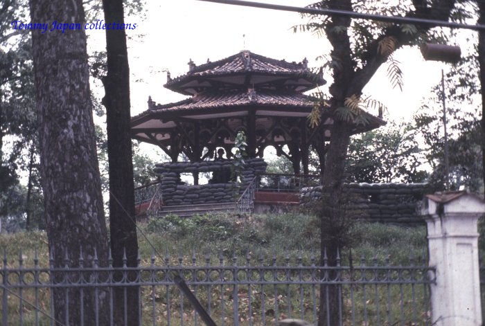 a gazebo in a park sits among some trees