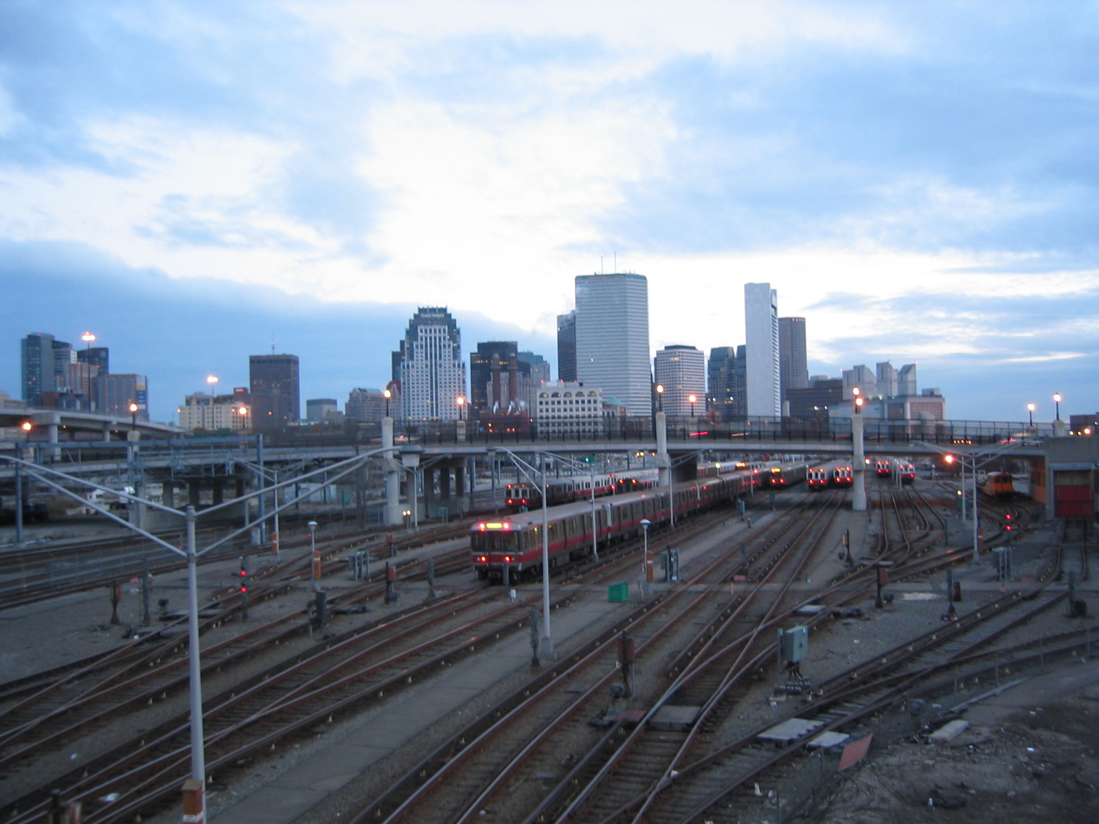 a train traveling past tall buildings near a rail line