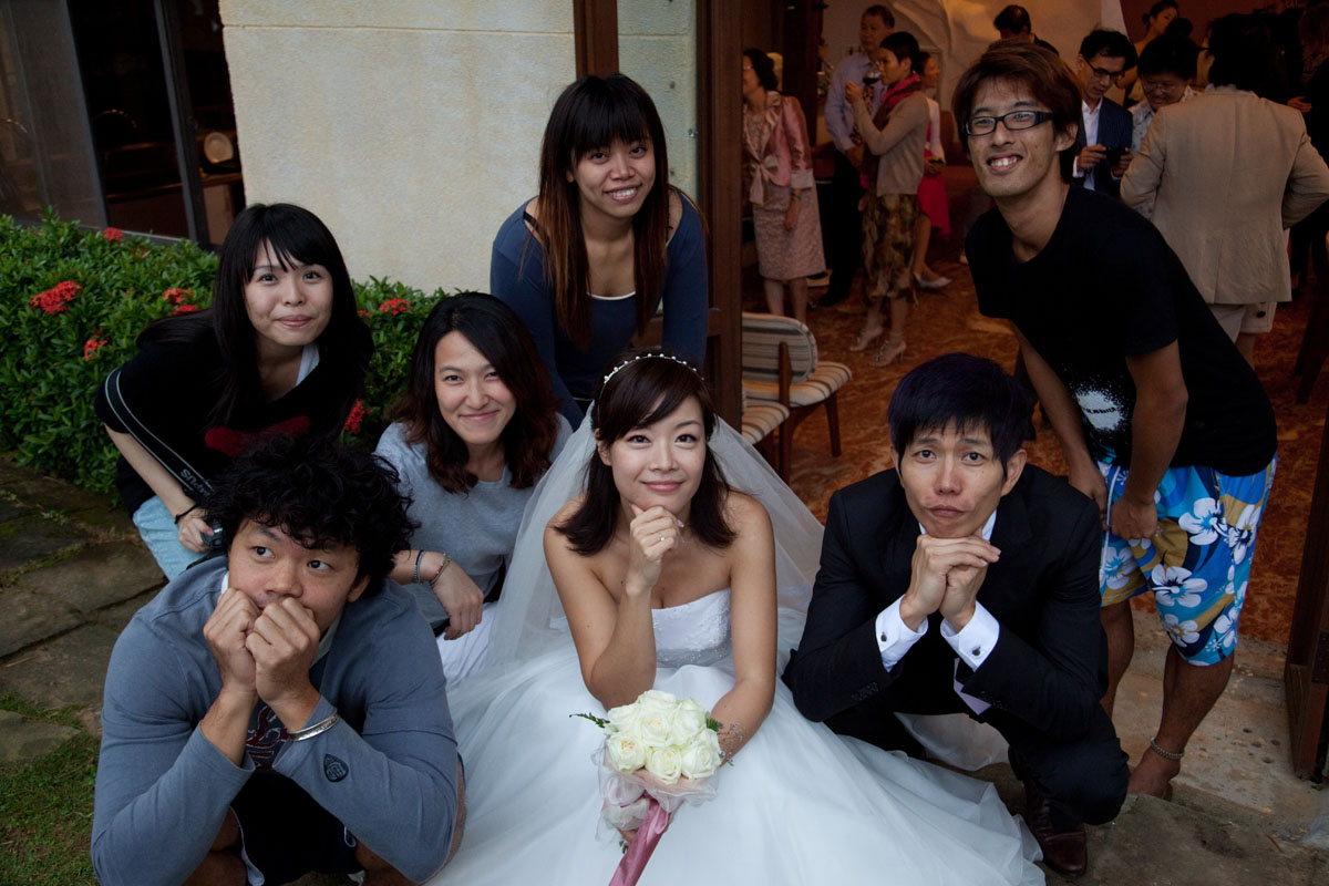 a wedding party posing in the middle of a group