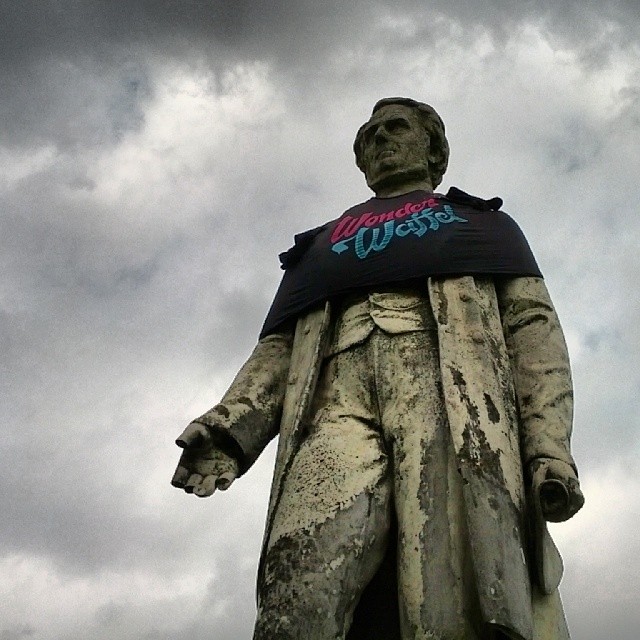 a large statue of a person with some writing on it