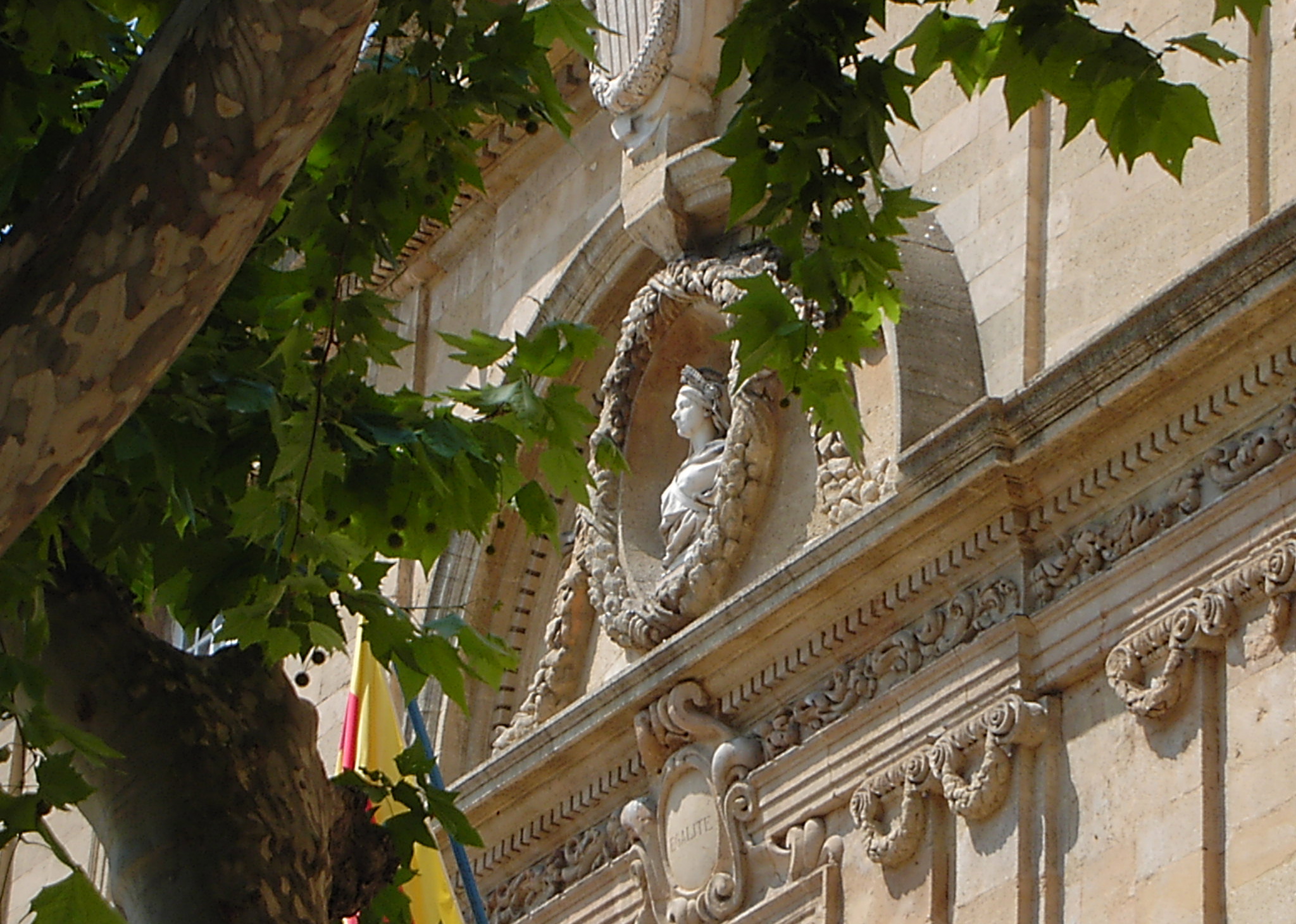 a statue is seen above some building