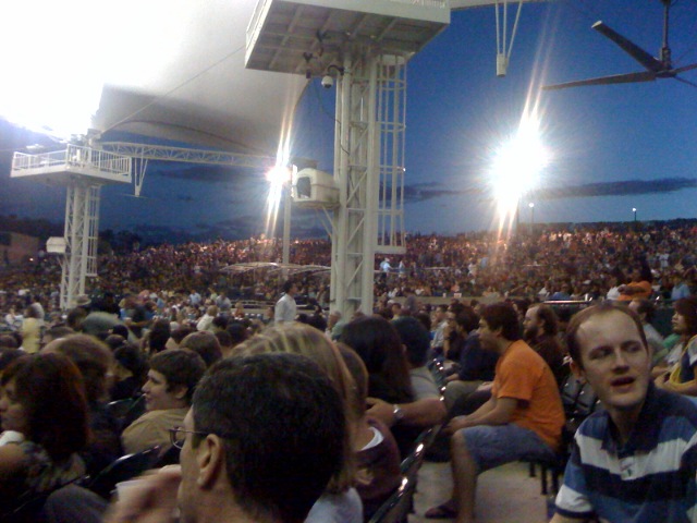 a large crowd is sitting together in the stadium
