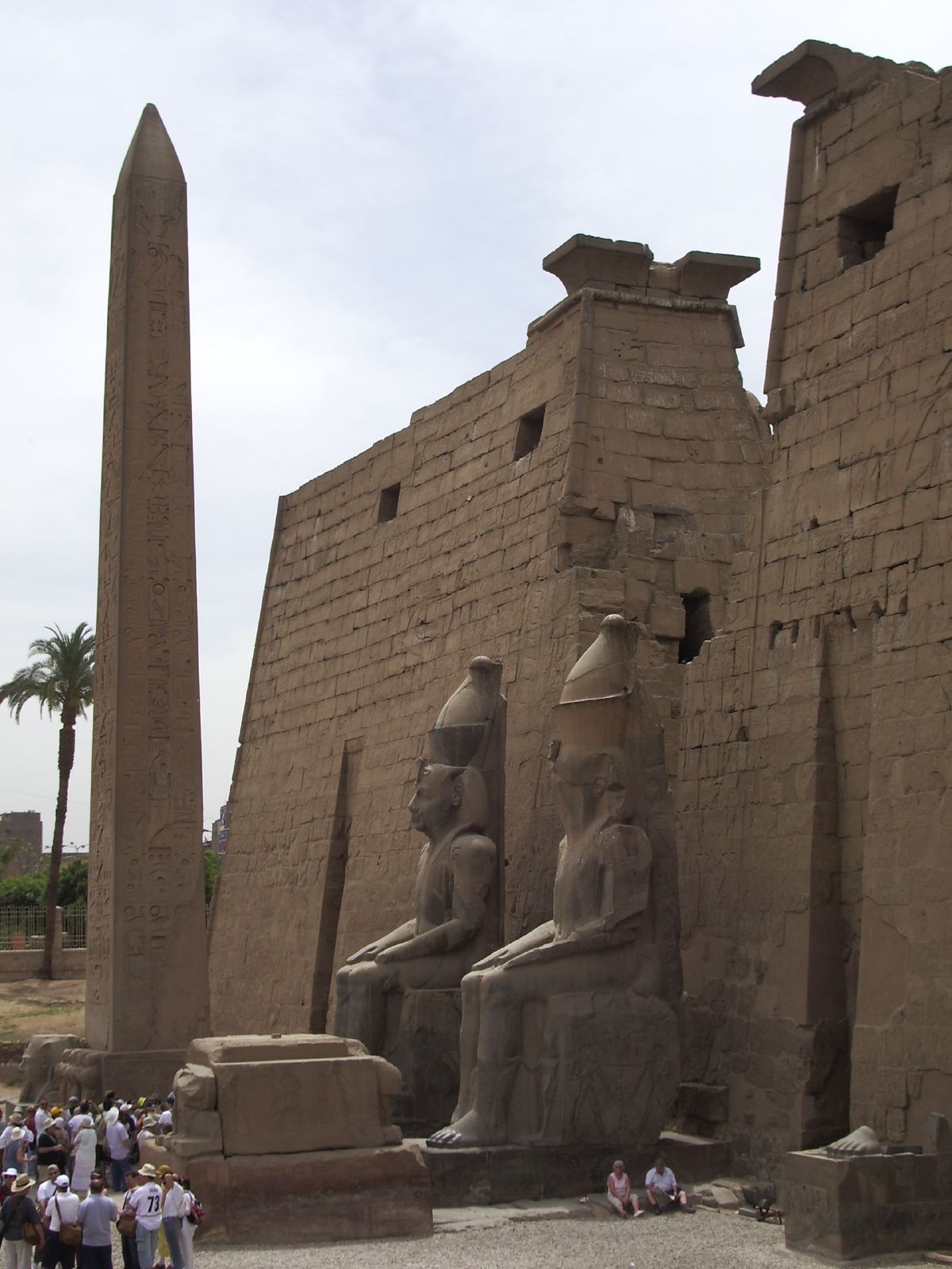 a couple of very tall ancient buildings with statues