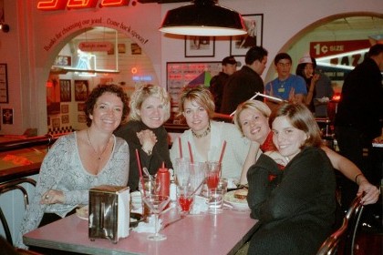 four women are sitting at a table in a restaurant