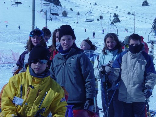 a crowd of people posing on a ski slope