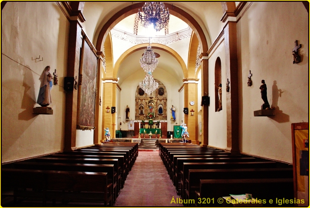 an aisle with pews leading to large wooden alters