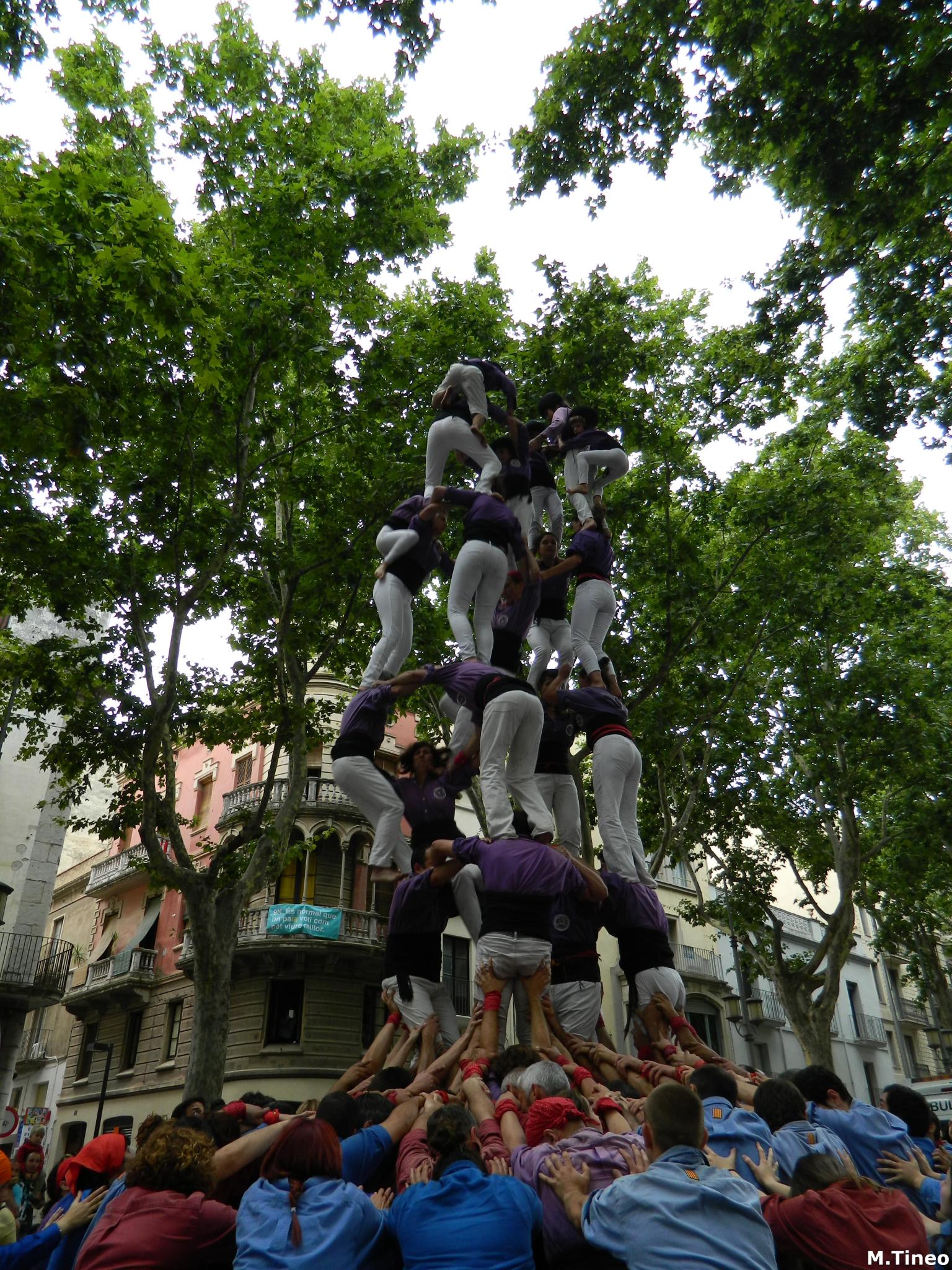 a group of people standing in the middle of an upside down sculpture