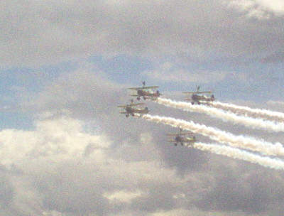 the four airplanes are all flying in formation