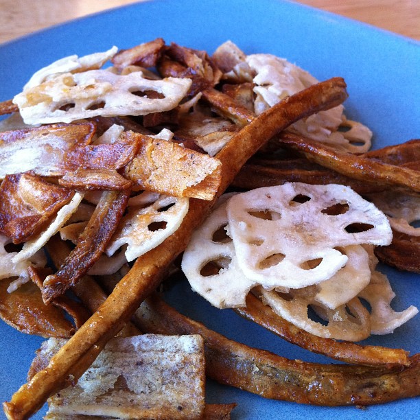 cooked food items displayed on blue plate with wood flooring