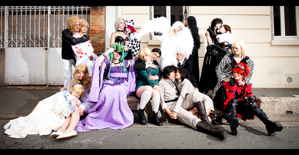 several people in costumes posing for a group po