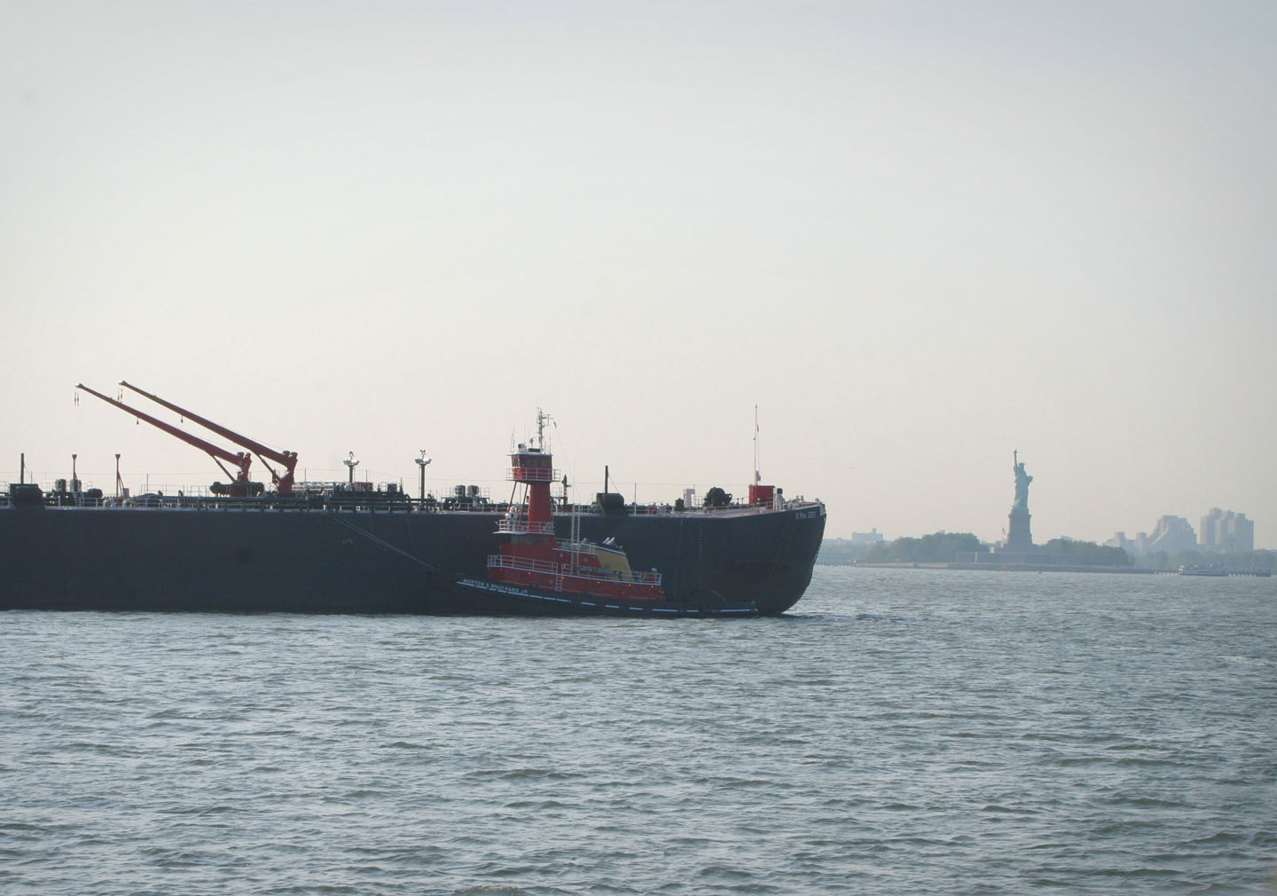 a large ship floats in the water with cranes on top