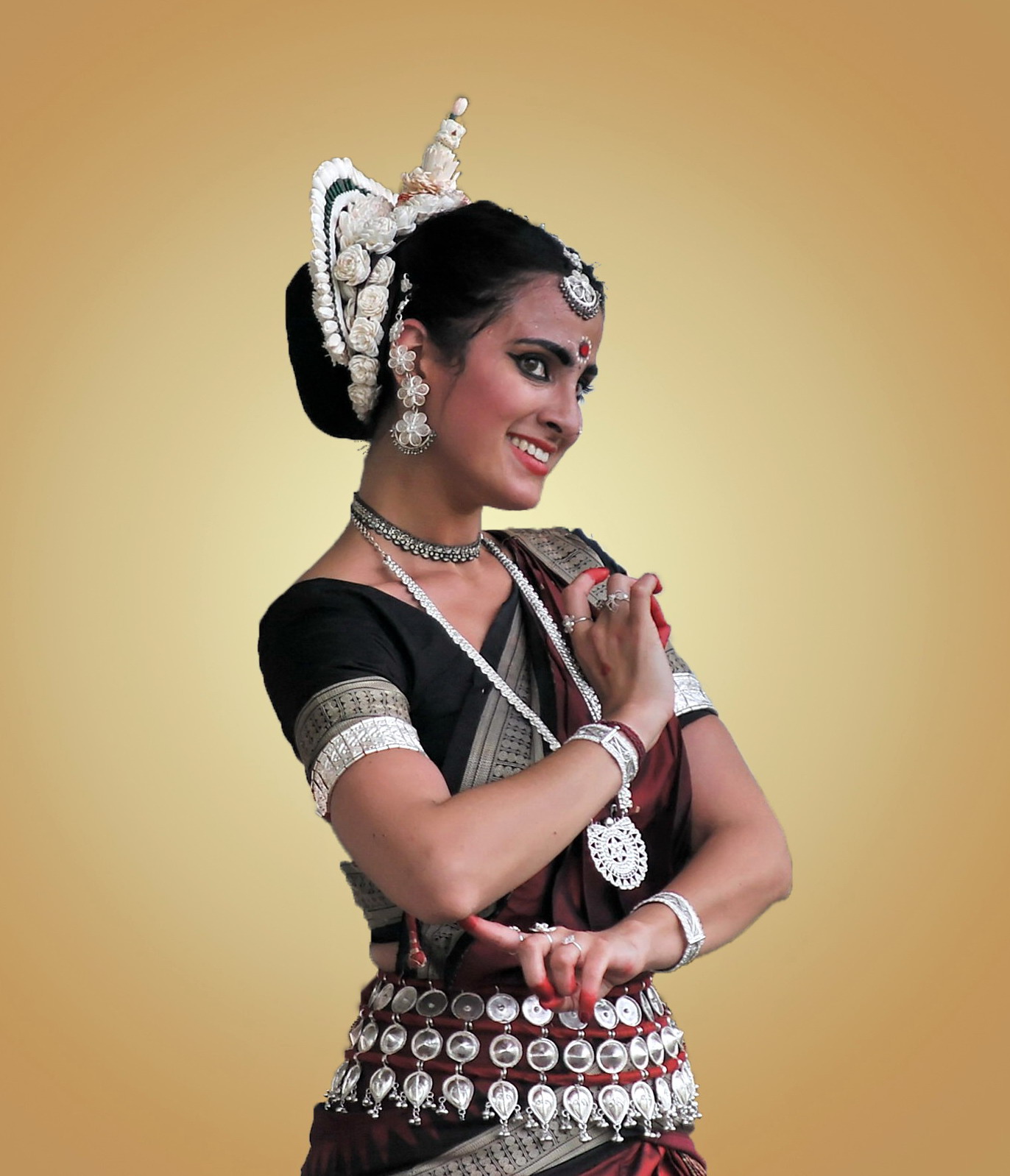 a woman in traditional indian garb posing for a portrait