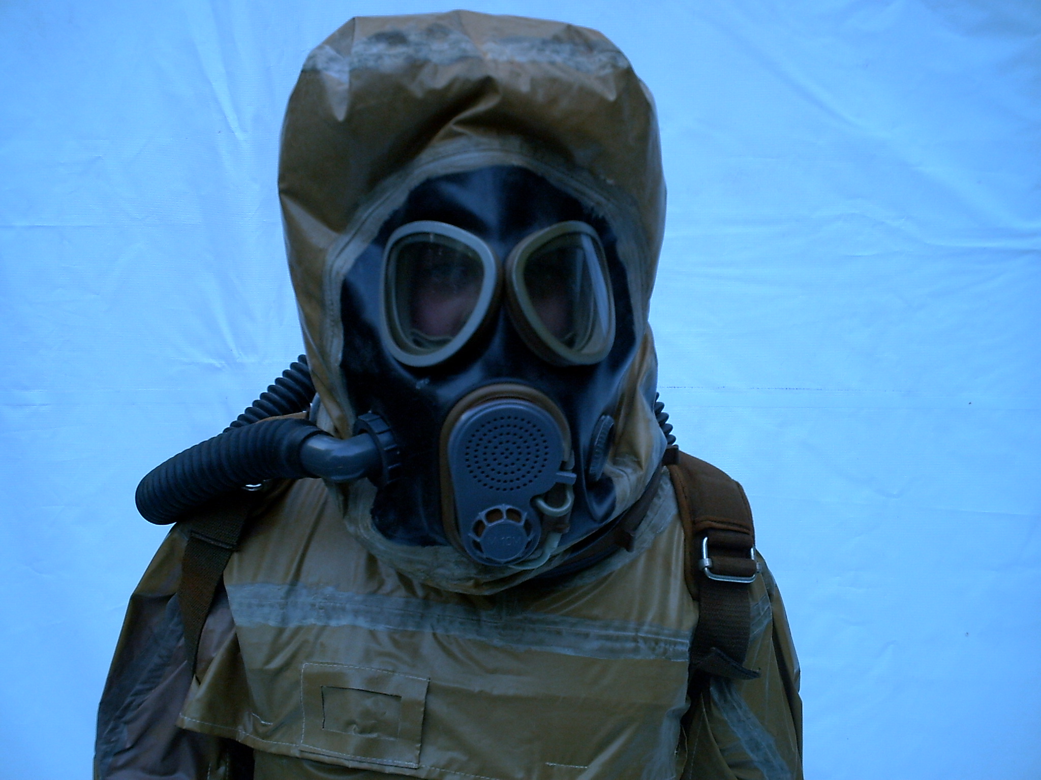 a person wearing a gas mask and jacket