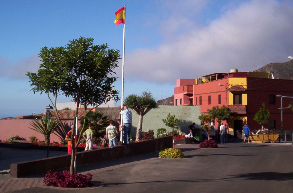 people looking out over a town square from outside