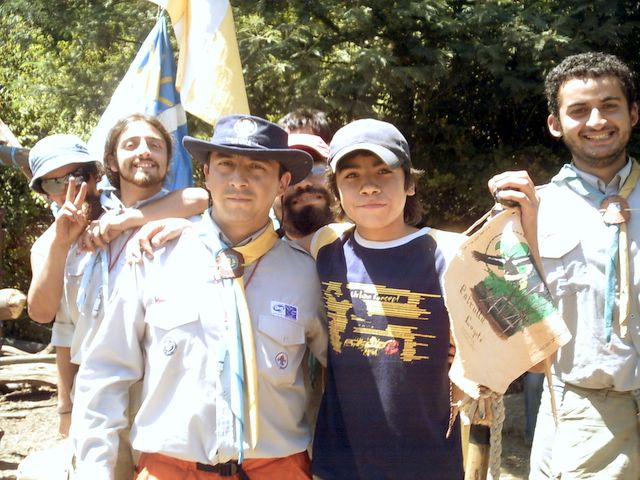 a group of people with hats and ties posing for the camera