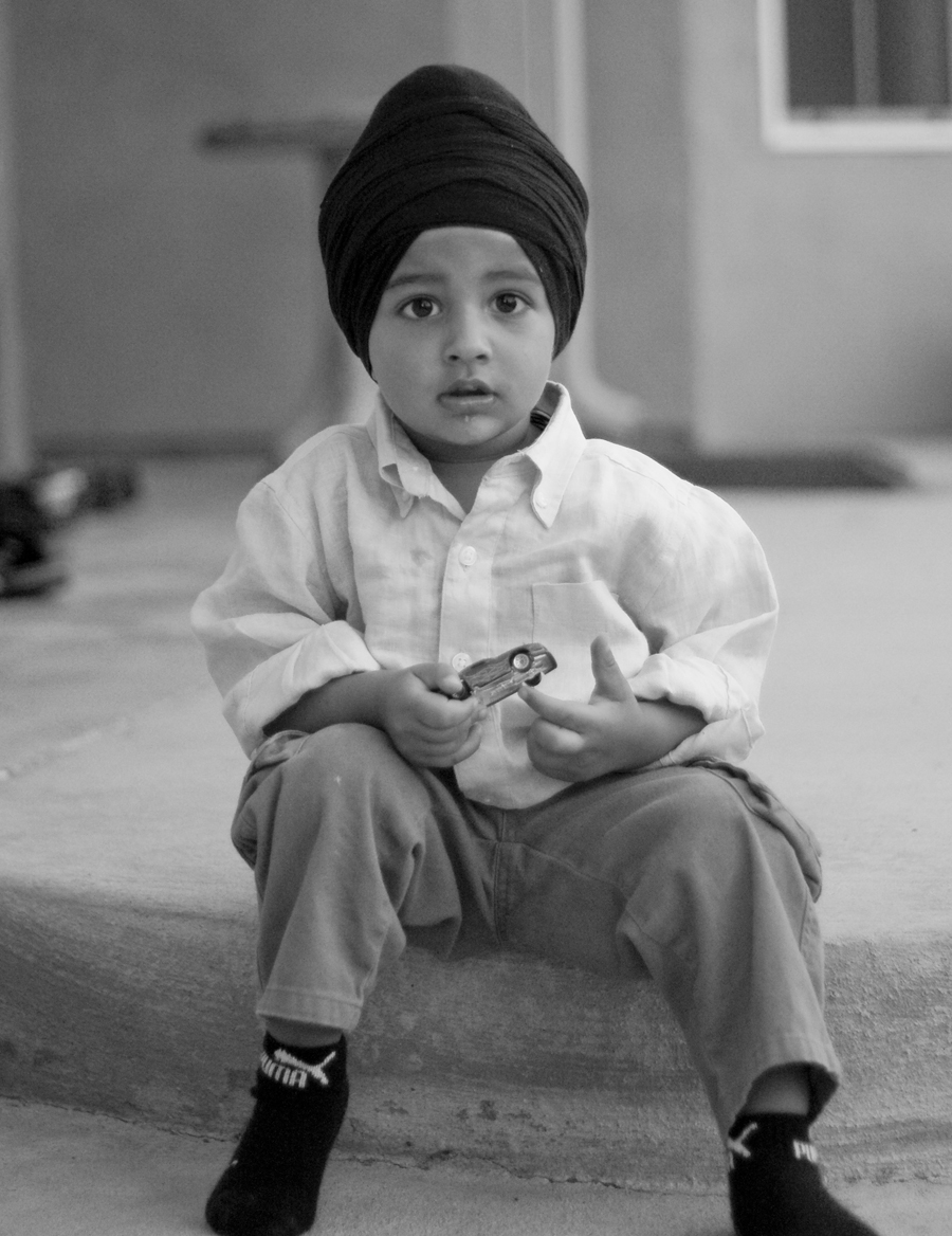 black and white pograph of a child sitting on steps