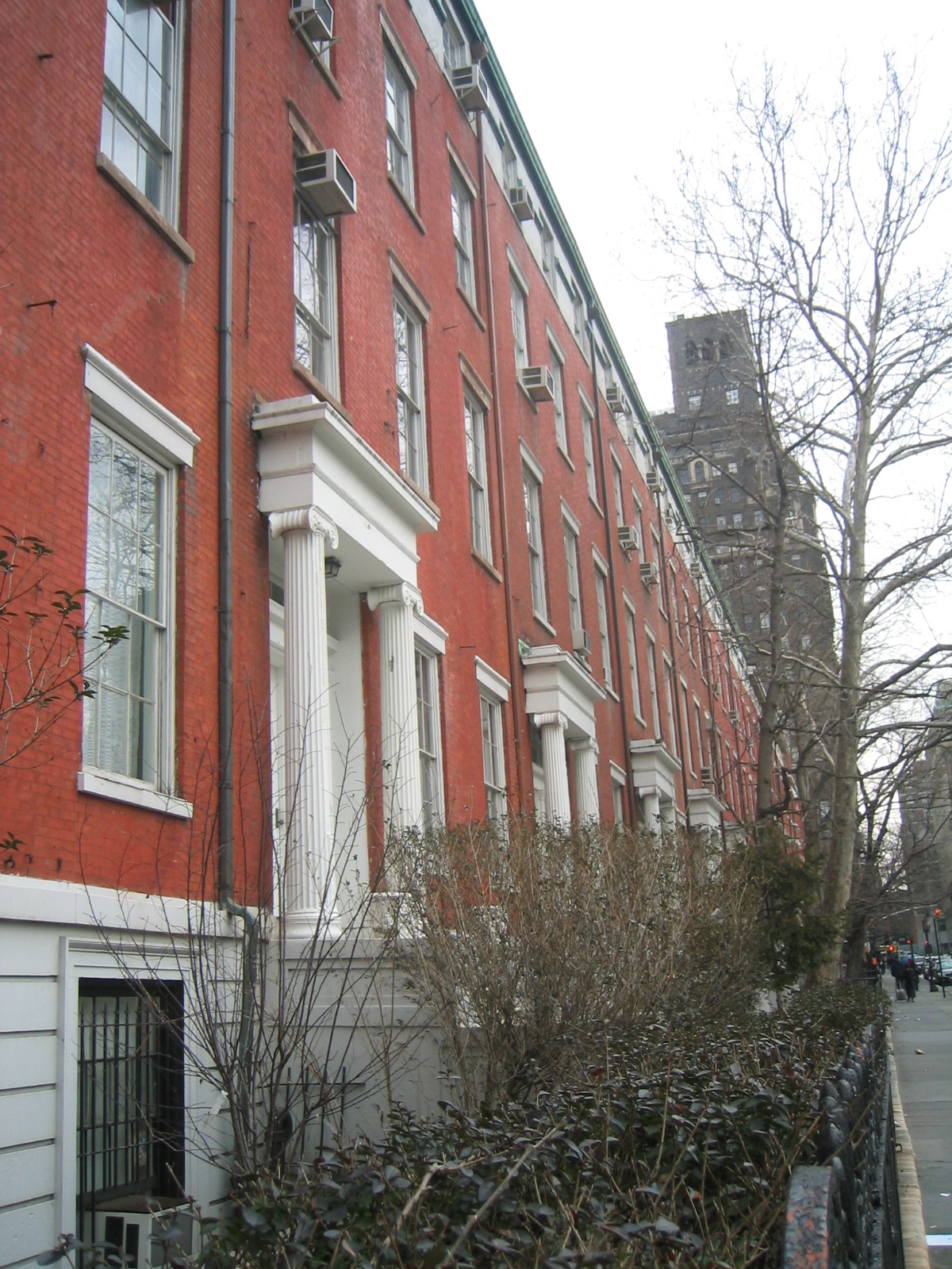 the building is red with white trim and tall windows