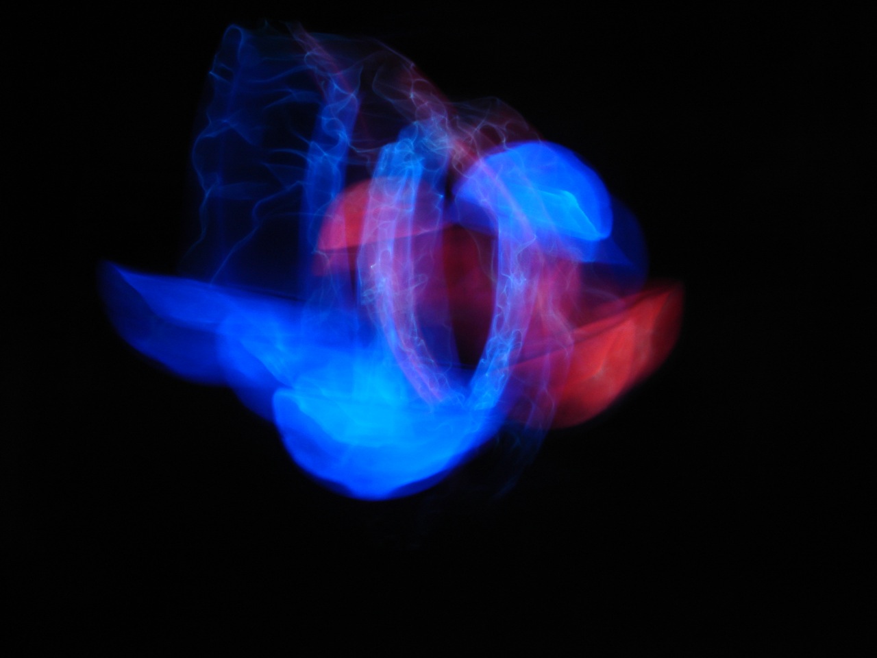 a blurry image of a blue and red ring