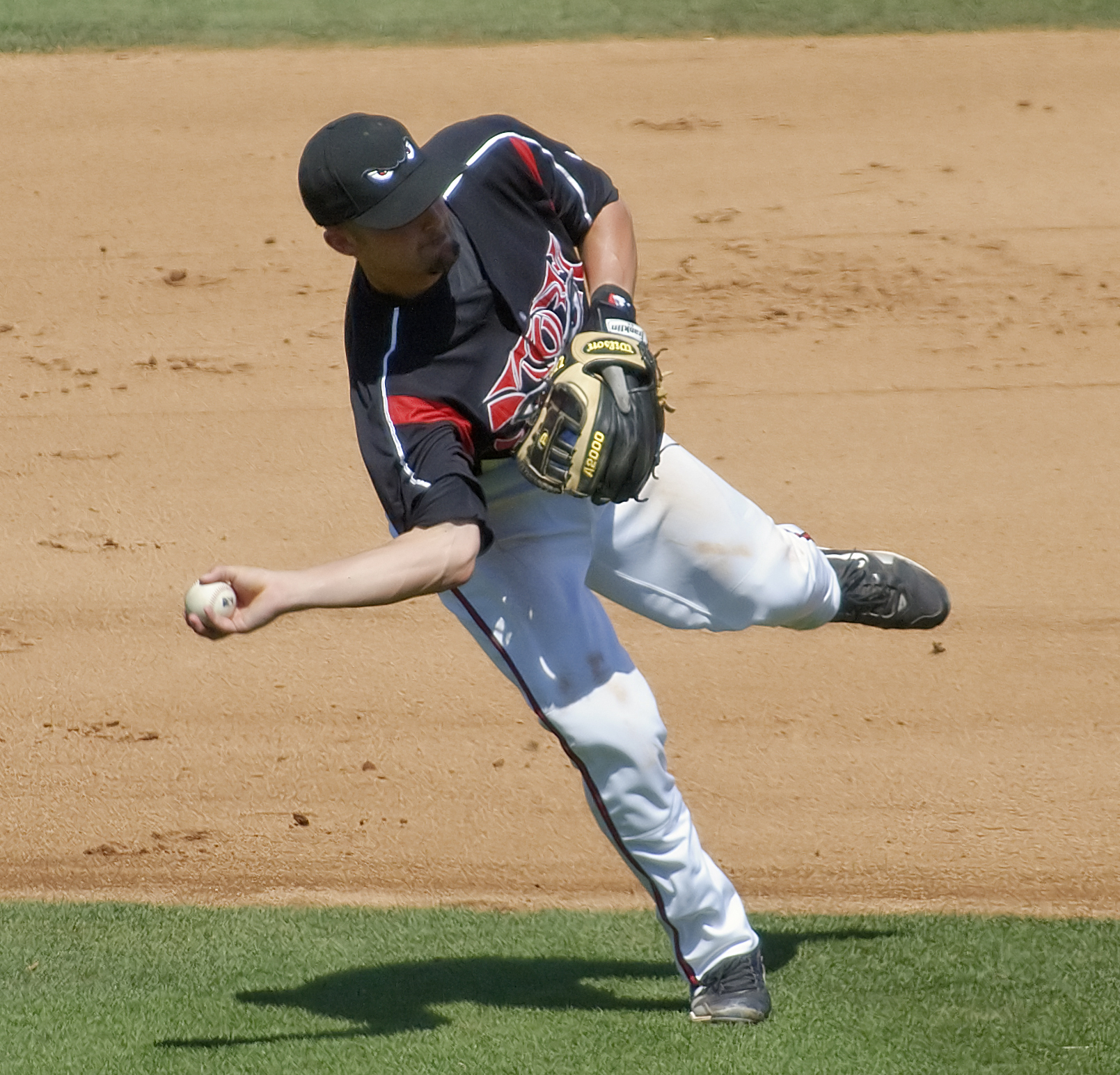 a pitcher in the motion of throwing the ball