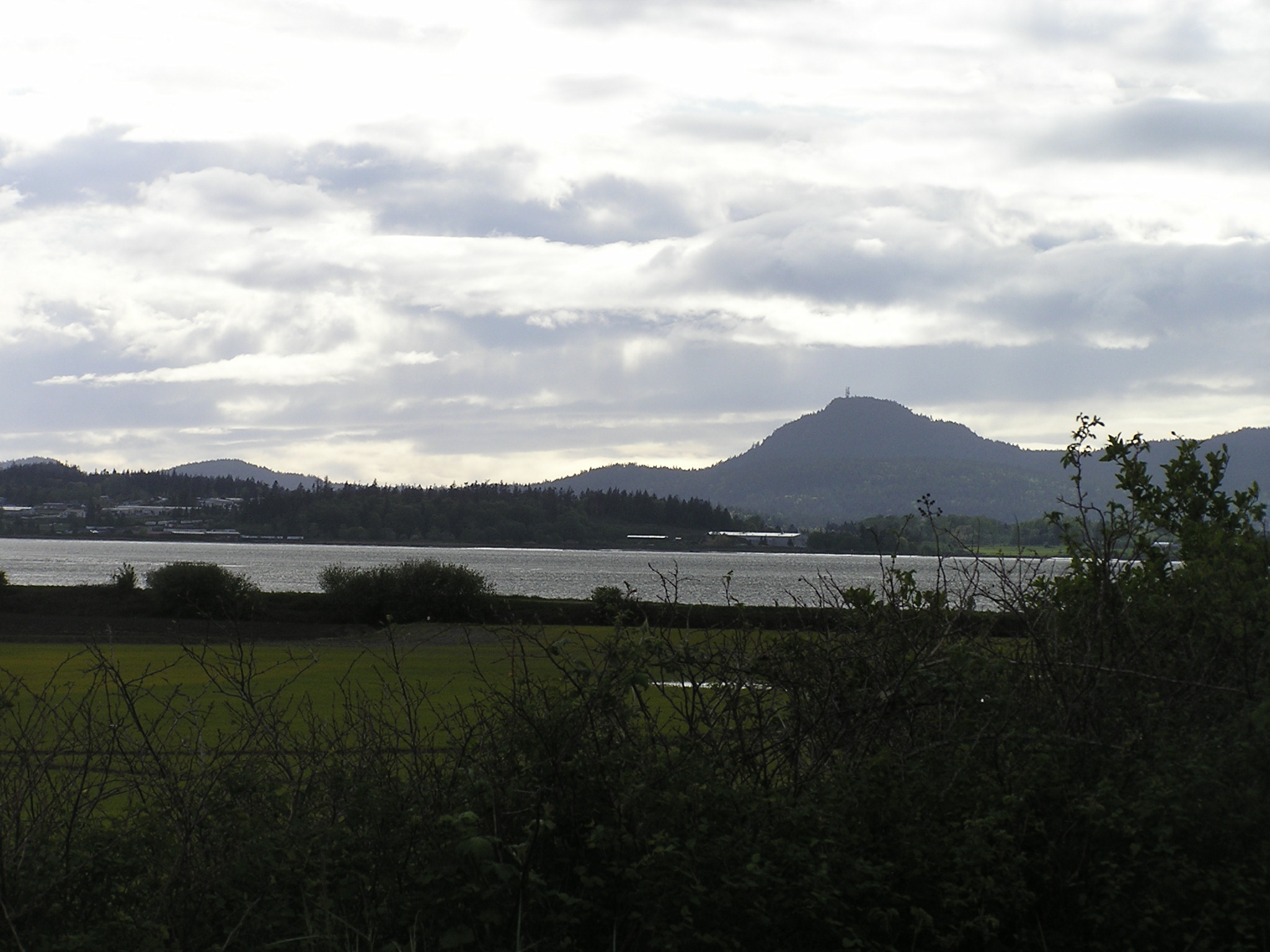 a view of water and a distant hill