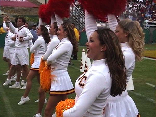 a group of cheerleaders performing stunts during the football game