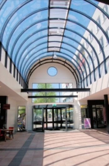 an empty, large building with glass ceilings and doors