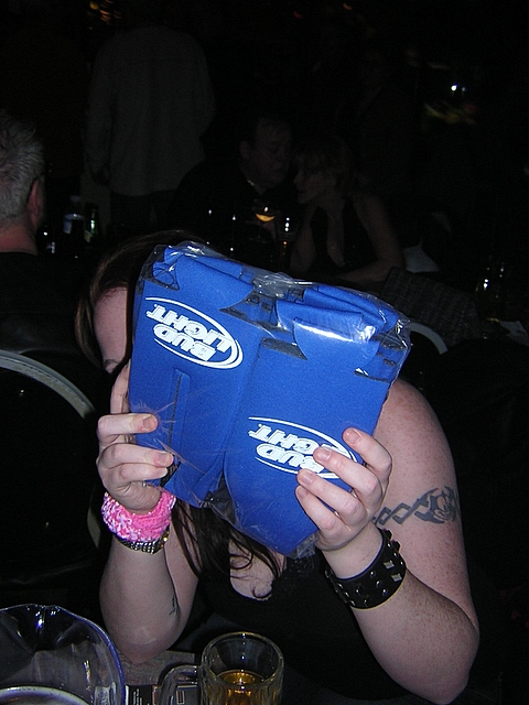 a woman holding a large blue piece of luggage