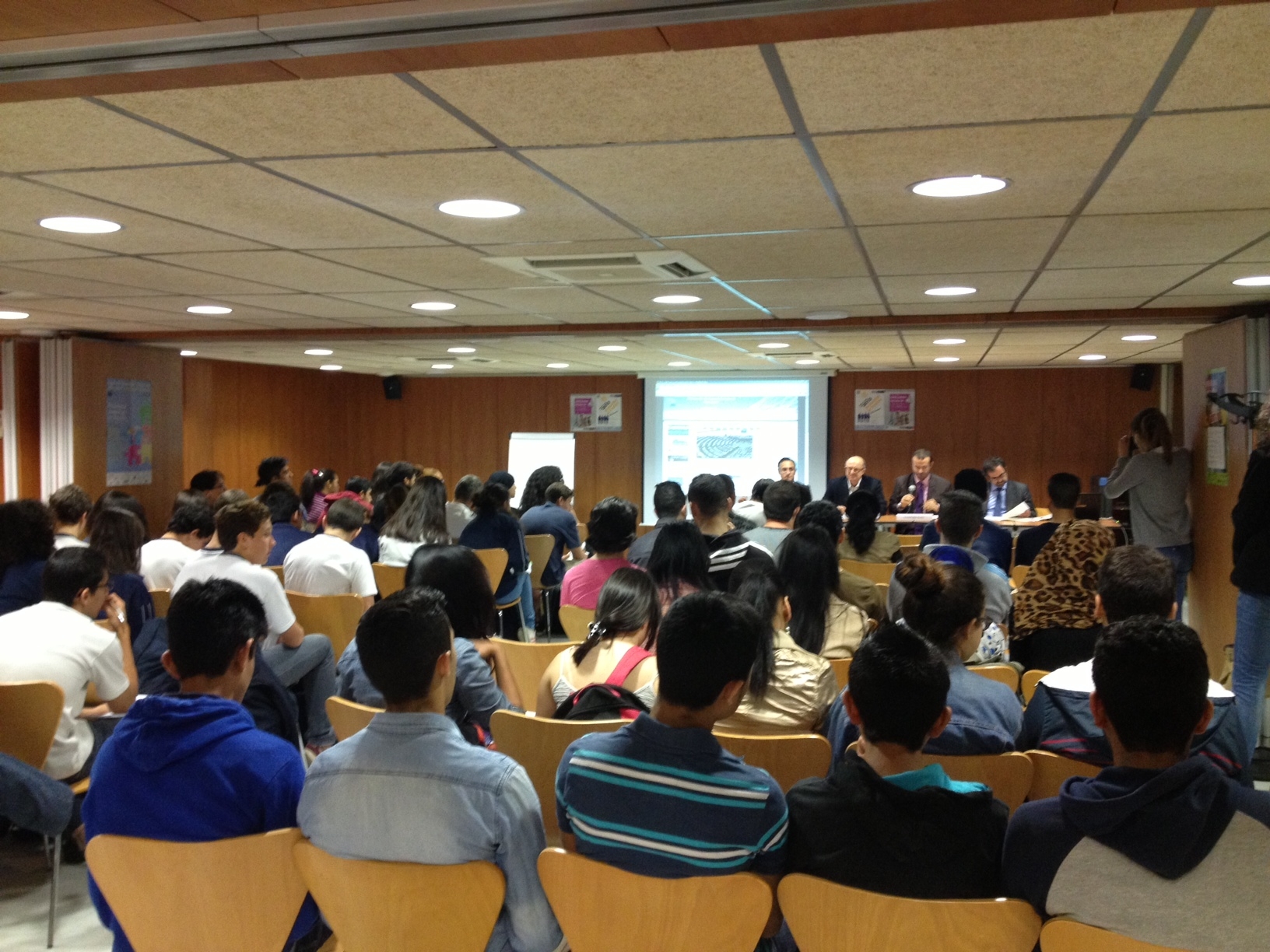 a crowd is seen in a room with the speaker