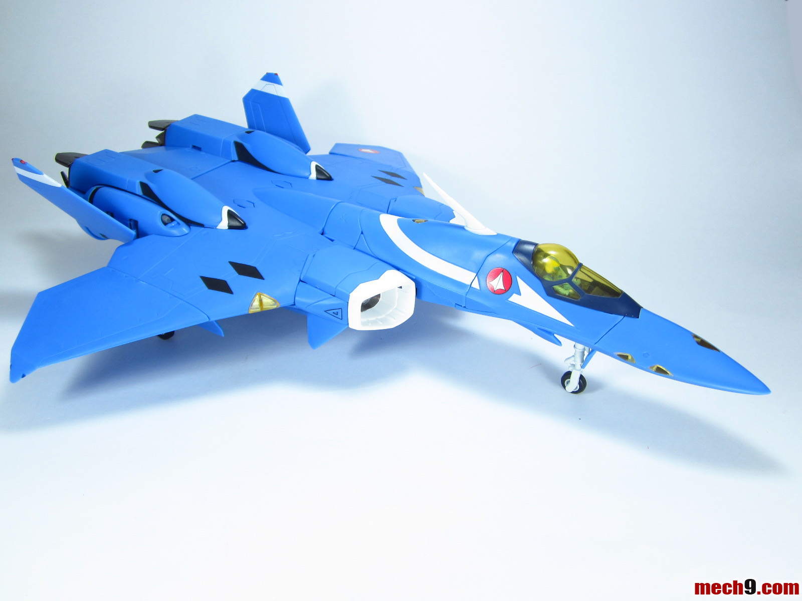 a toy fighter jet on a white surface