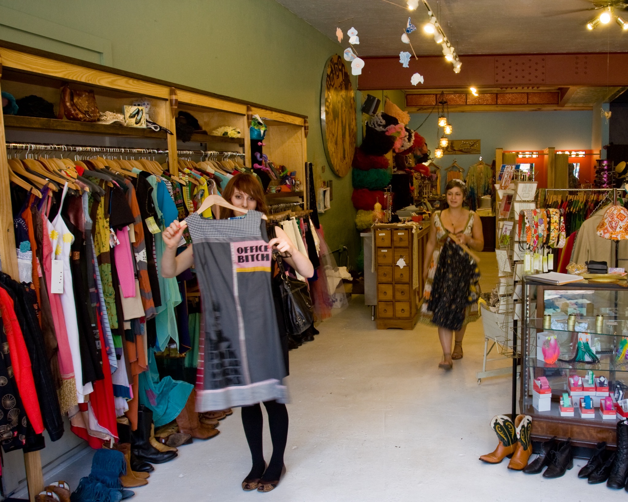 woman in a shop showing off her clothing