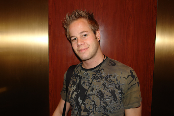 young man with mohawk standing in an elevator
