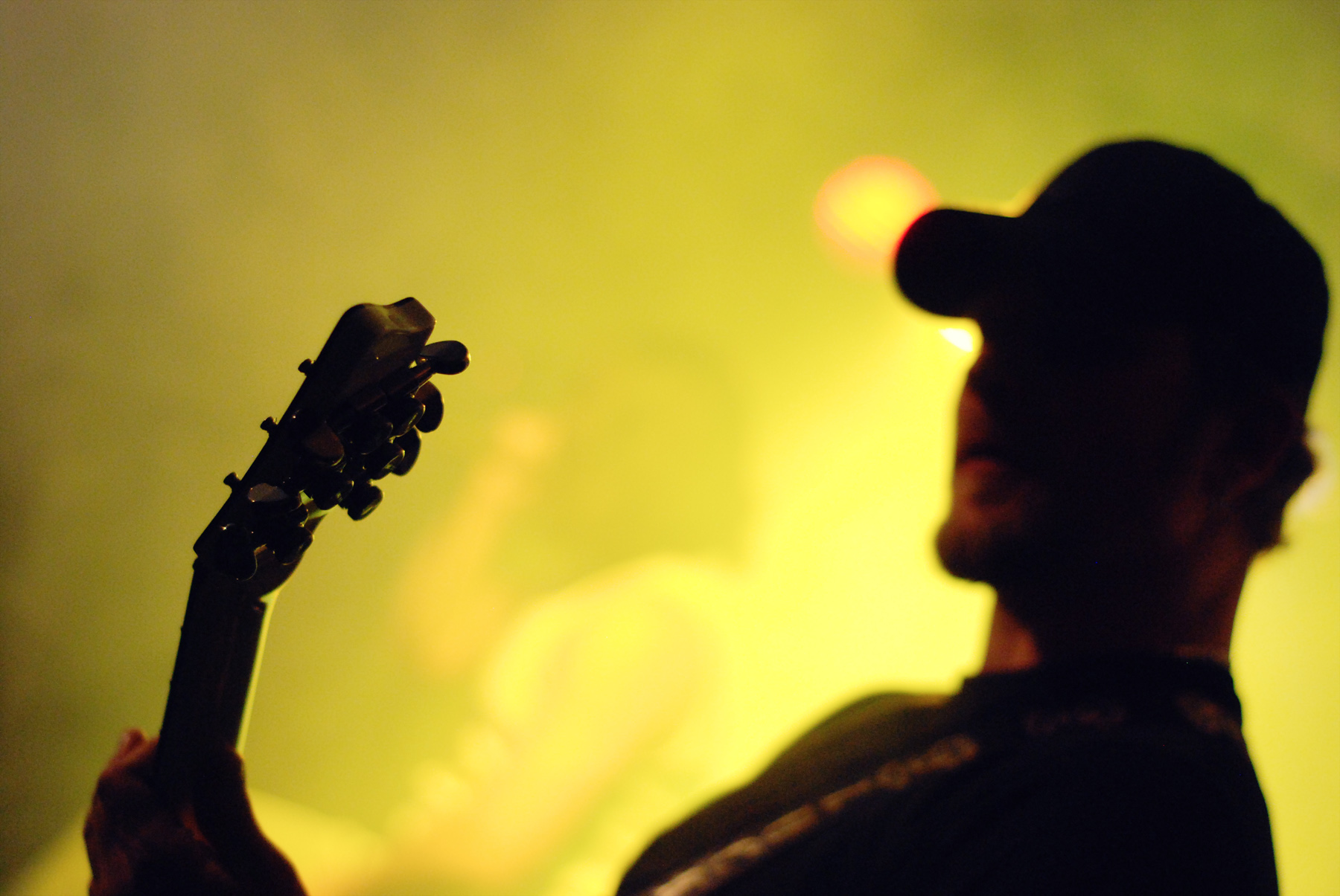a man holding a guitar at a concert