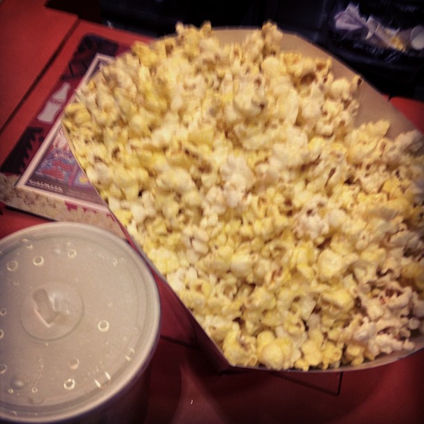 a big bowl of popcorn and a box of chips