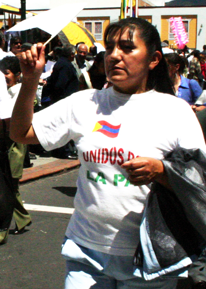 a woman in white holds a flag and waves