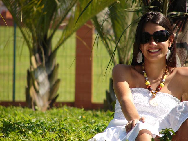 a woman wearing sunglasses and a white dress