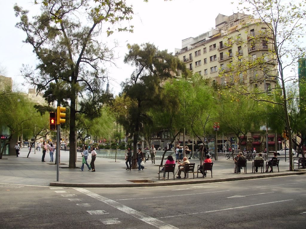 several people sitting at outdoor tables near trees