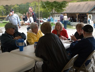 group of people sitting at a table talking