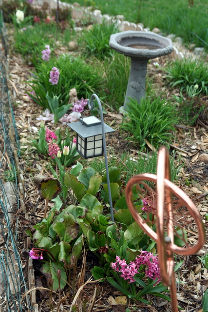 a garden with a small lamp in it