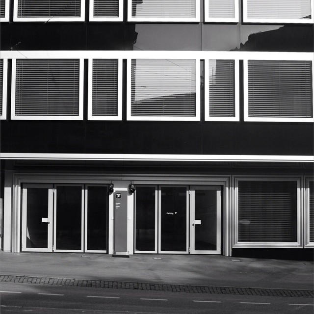 the building has shutters and is black and white