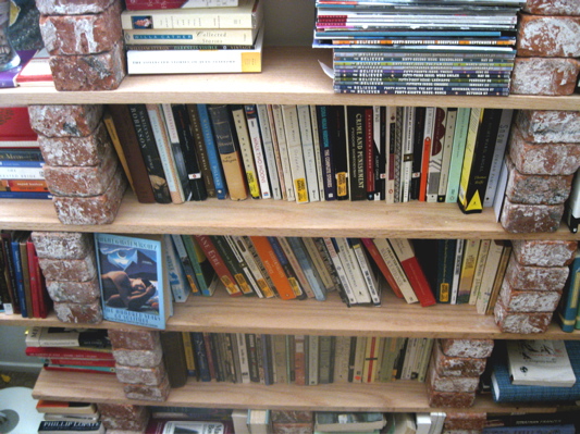 a shelf with lots of books on it