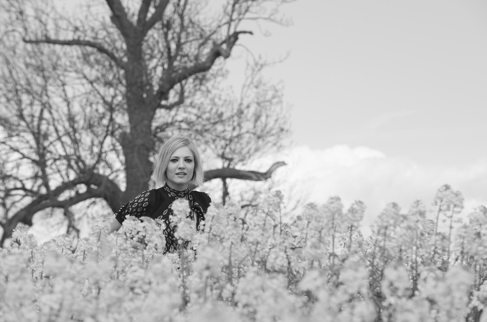 a lady that is standing in a field