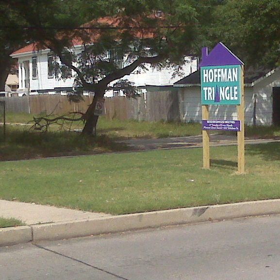 a sign on a suburban street near houses