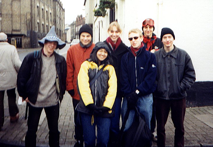 a group of men pose together on a street